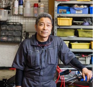 Senior male mechanic in his motorcycle repair shop